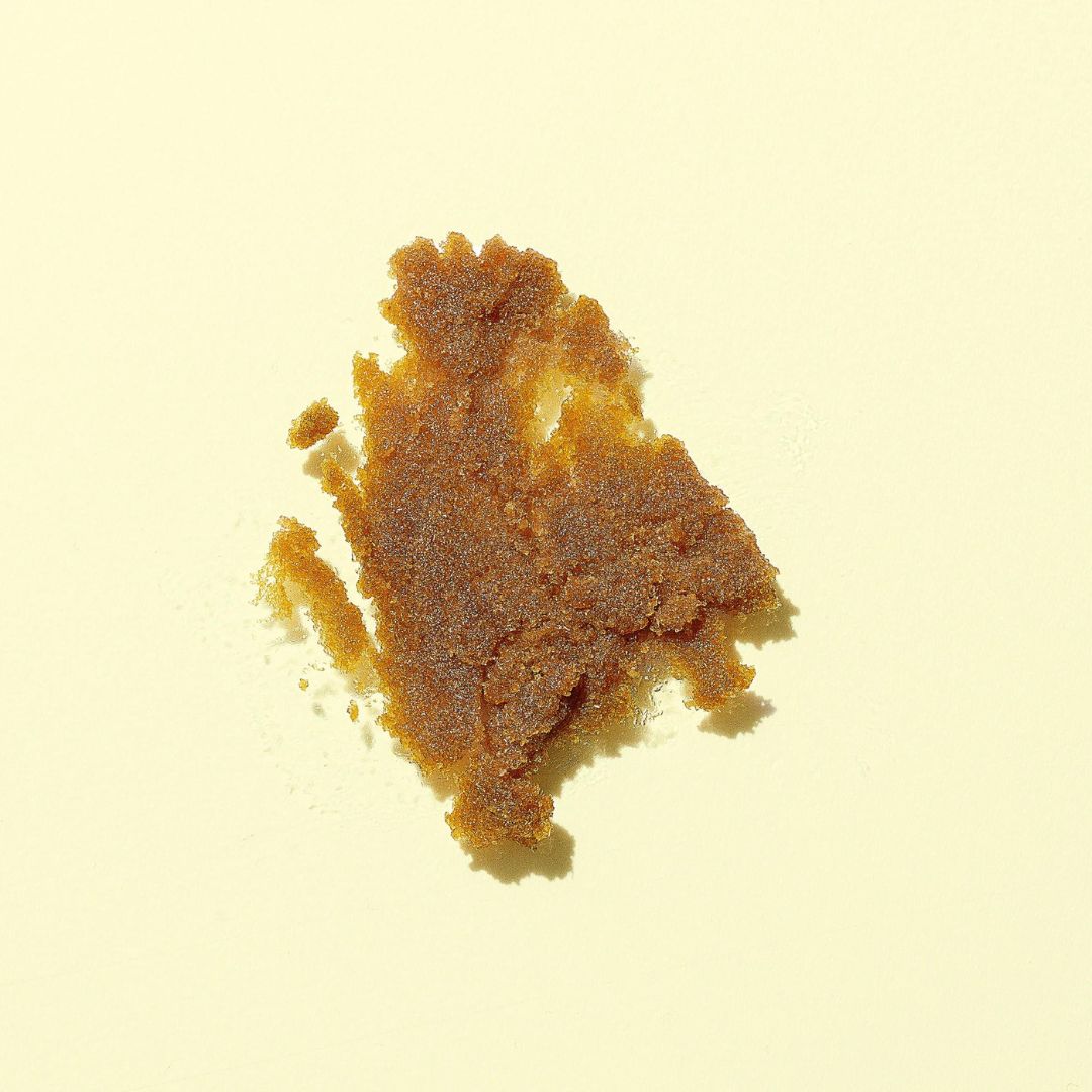 Image of the Woohoo Spoonful of Sugar Exfoliating Scrub formula on a yellow background